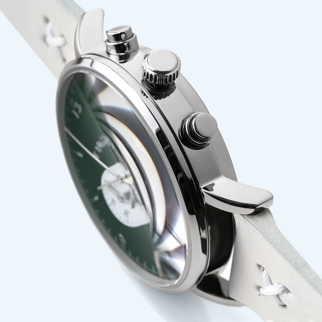 Side view of a polished analog watch case highlighting crown and bezel details.